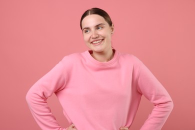 Photo of Beautiful woman laughing on pink background. Positive emotion