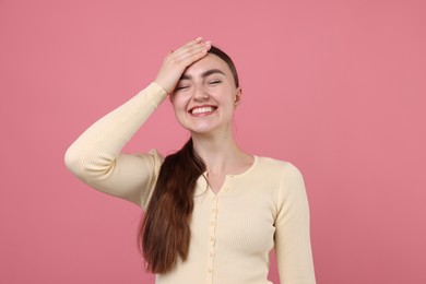 Photo of Beautiful woman laughing on pink background. Positive emotion