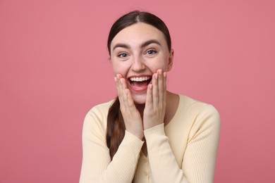 Photo of Beautiful woman laughing on pink background. Positive emotion