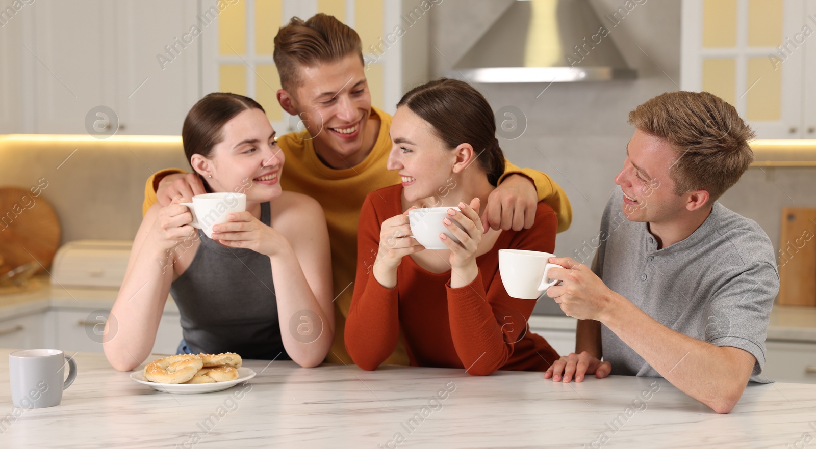 Friends with coffee laughing in kitchen. Positive emotion Photo of Friends with coffee laughing in kitchen. Positive emotion