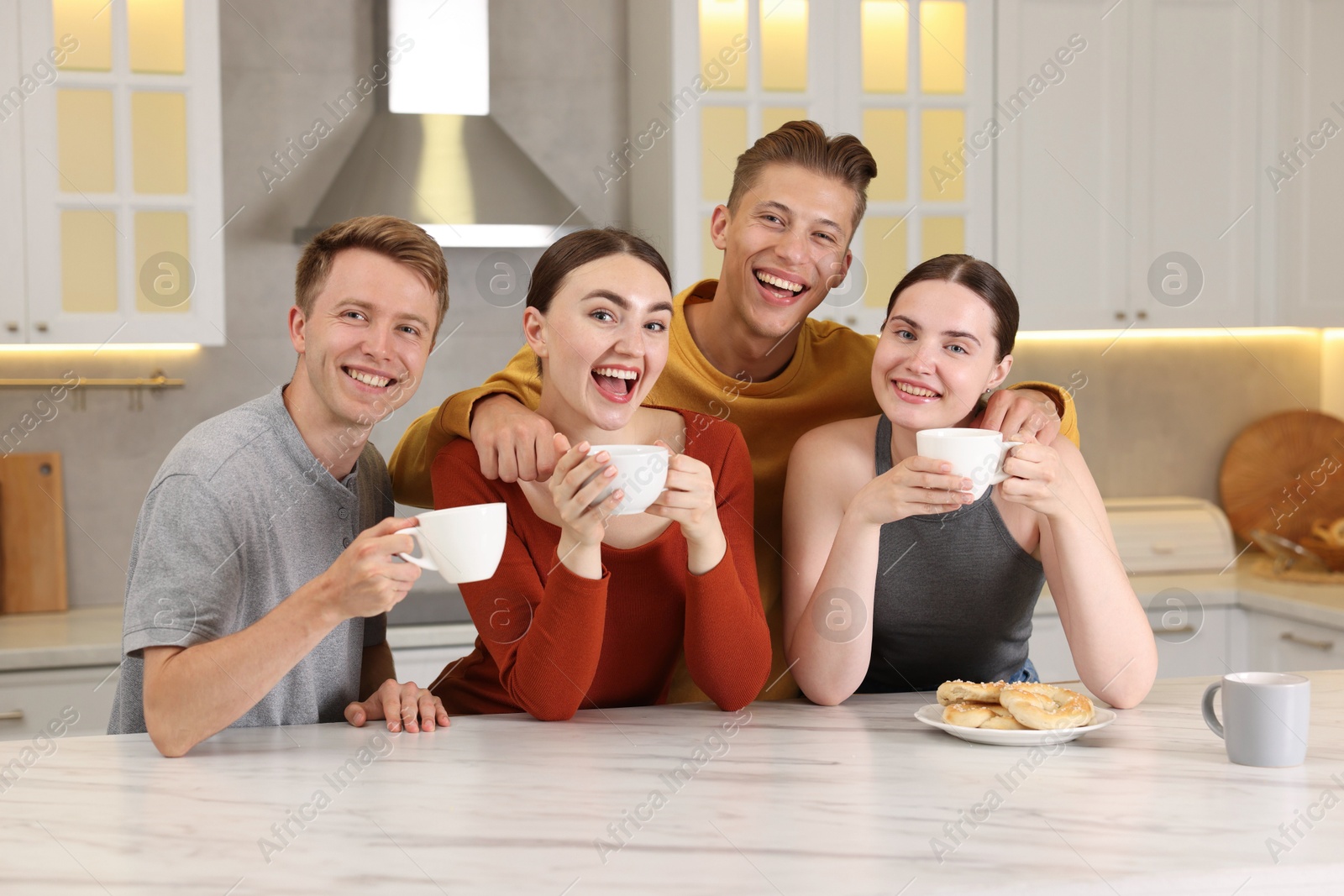 Friends with coffee laughing in kitchen. Positive emotion Photo of Friends with coffee laughing in kitchen. Positive emotion
