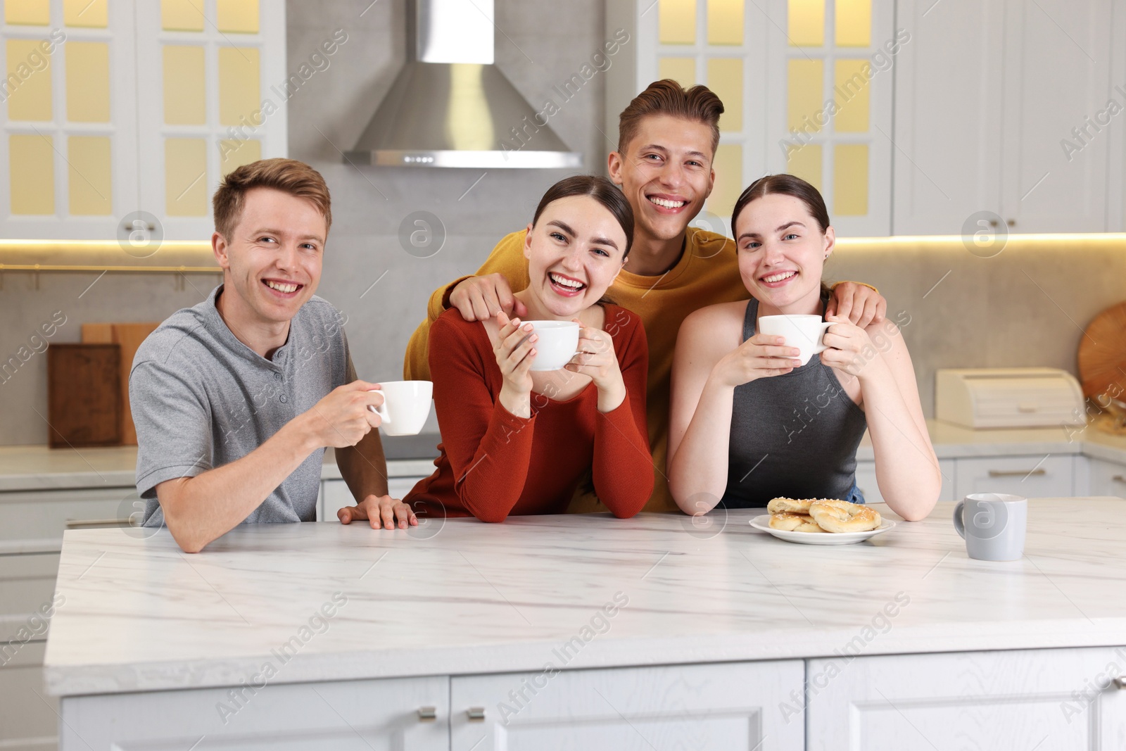 Friends with coffee laughing in kitchen. Positive emotion Photo of Friends with coffee laughing in kitchen. Positive emotion