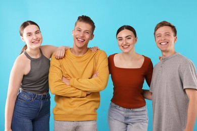 Photo of Friends laughing on light blue background. Positive emotion