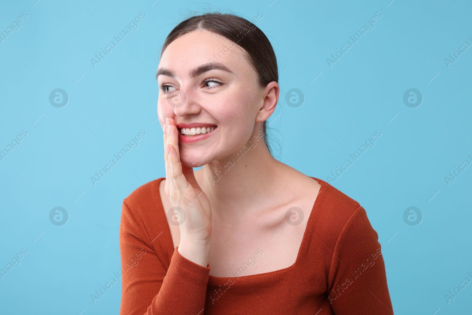 Beautiful woman laughing on light blue background. Positive emotion Photo of Beautiful woman laughing on light blue background. Positive emotion