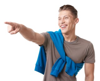 Photo of Handsome man laughing and pointing at something on white background. Positive emotion