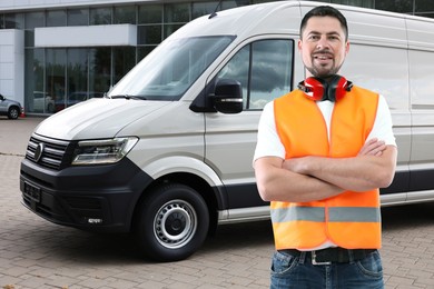 Image of Car service worker in orange vest and vehicle outdoors
