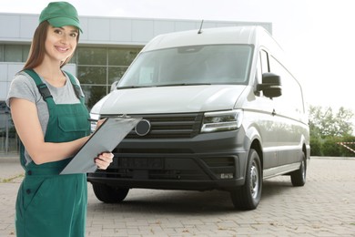 Image of Car service worker with clipboard and vehicle outdoors