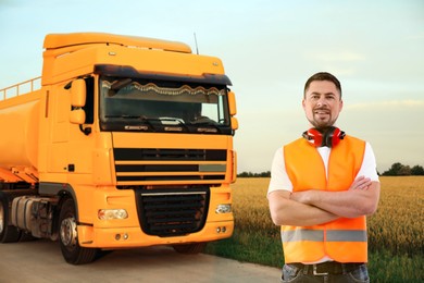 Image of Car service worker and orange truck outdoors