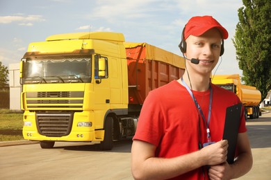 Image of Car service worker with headset and clipboard against trucks outdoors. Client support