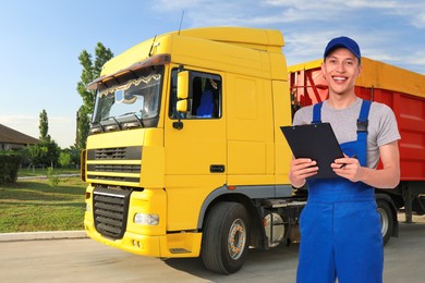 Image of Car service worker with clipboard and truck outdoors