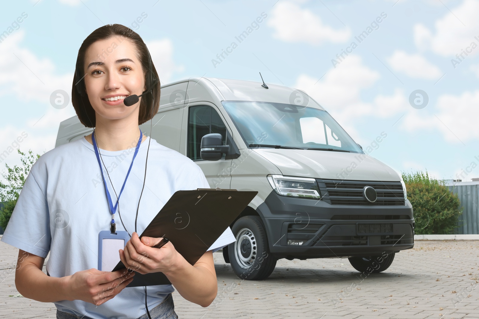 Image of Car service worker with headset and clipboard against vehicle outdoors. Client support