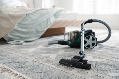 Photo of One vacuum cleaner on floor indoors. Household appliance