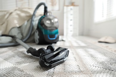 Photo of One vacuum cleaner on floor indoors, closeup