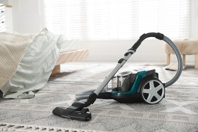 Photo of One vacuum cleaner on floor indoors. Household appliance