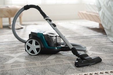 Photo of One vacuum cleaner on floor indoors. Household appliance