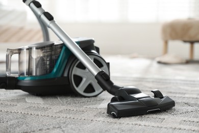 Photo of One vacuum cleaner on floor indoors, closeup
