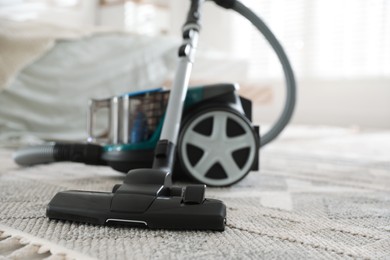 Photo of One vacuum cleaner on floor indoors, closeup