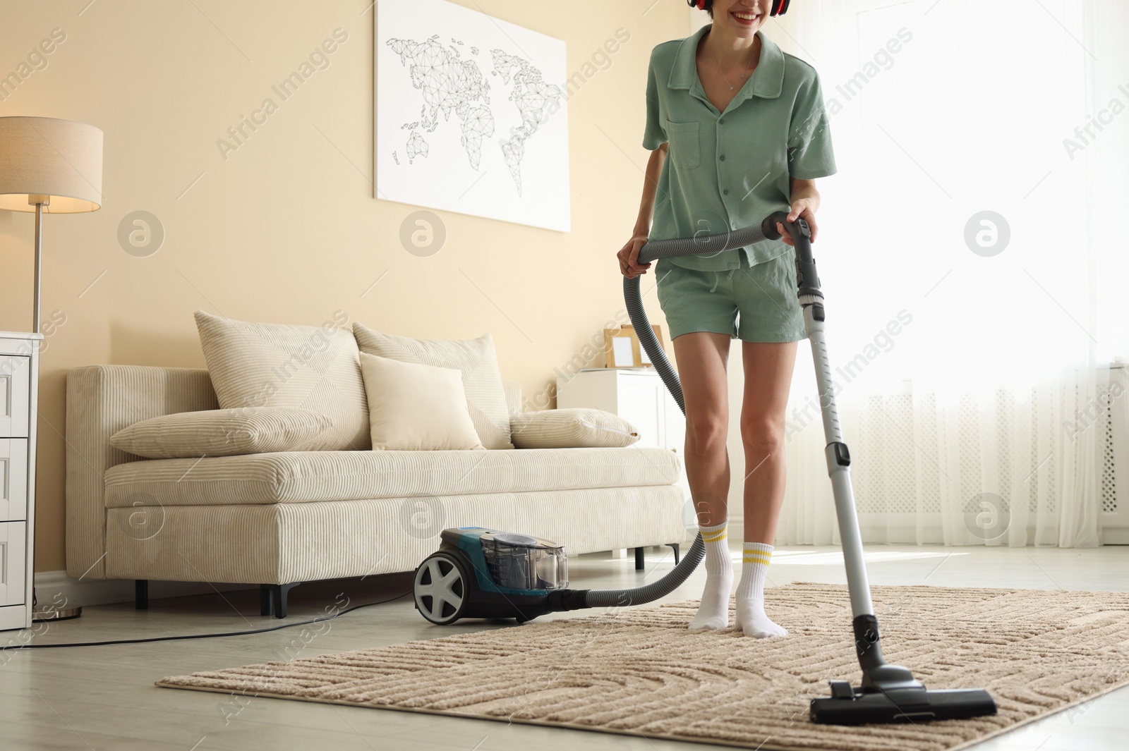 Woman cleaning carpet with vacuum cleaner at home, closeup Photo of Woman cleaning carpet with vacuum cleaner at home, closeup