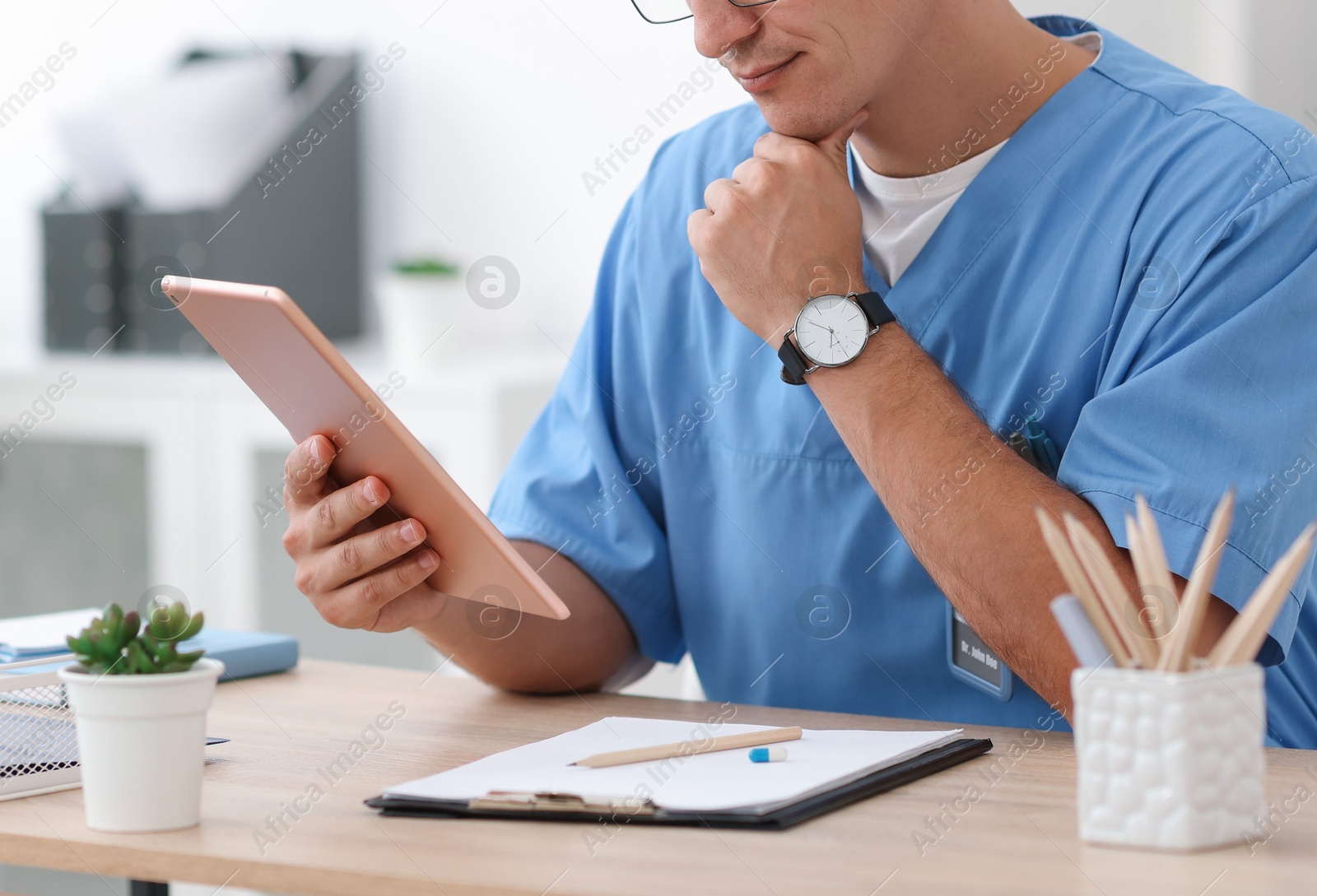 Photo of Telemedicine. Doctor having video call with patient via tablet indoors, closeup