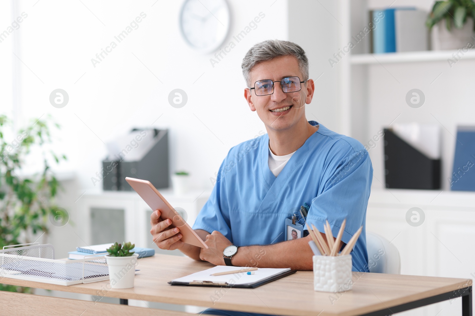 Photo of Telemedicine. Doctor having video call with patient via tablet indoors