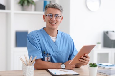 Photo of Telemedicine. Doctor having video call with patient via tablet indoors
