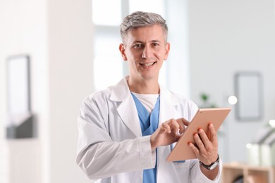 Photo of Telemedicine. Doctor with tablet having video call with patient, view from camera