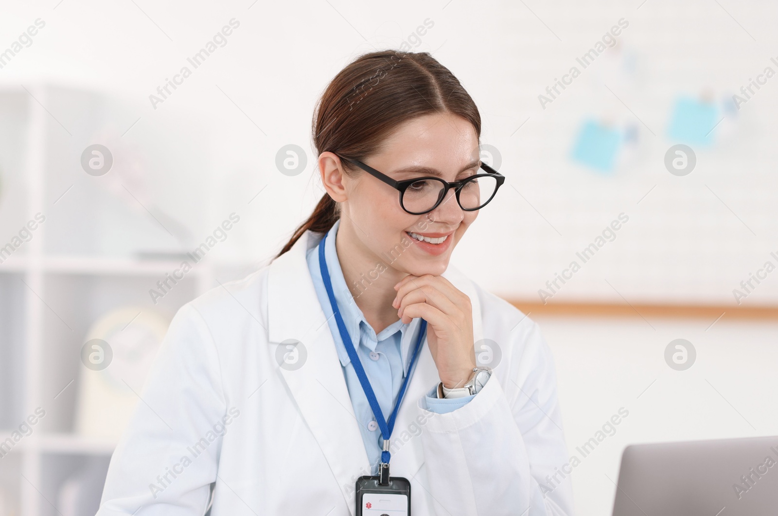 Telemedicine. Doctor having video call with patient via laptop indoors Photo of Telemedicine. Doctor having video call with patient via laptop indoors