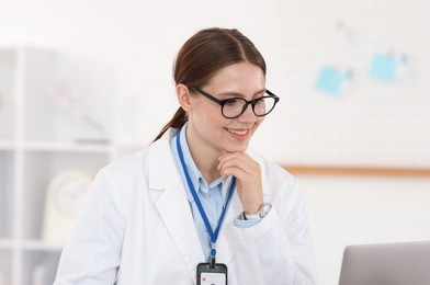 Photo of Telemedicine. Doctor having video call with patient via laptop indoors