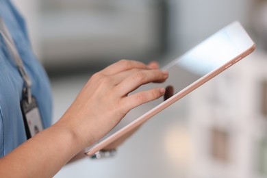 Photo of Telemedicine. Doctor with tablet in office, closeup
