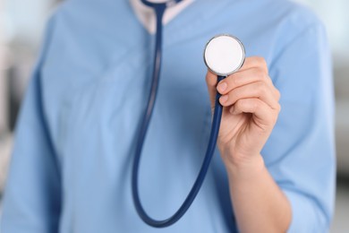 Photo of Telemedicine. Doctor with stethoscope in office, closeup