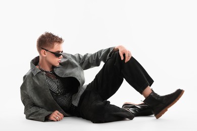 Photo of Handsome young man wearing stylish jacket and sunglasses on white background