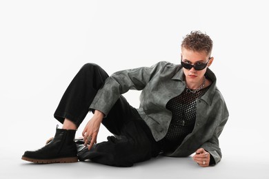 Photo of Handsome young man wearing stylish jacket and sunglasses on white background