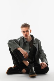 Photo of Handsome young man wearing stylish jacket on white background