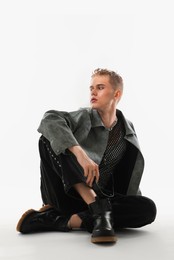 Photo of Handsome young man wearing stylish jacket on white background