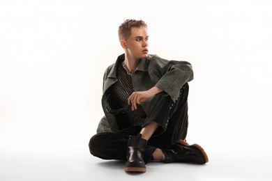 Photo of Handsome young man wearing stylish jacket on white background