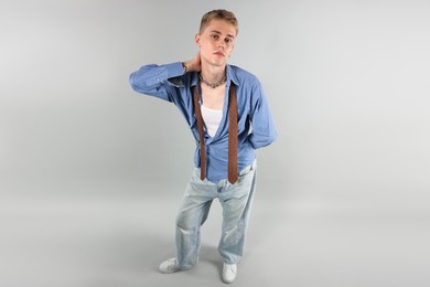 Photo of Handsome young man wearing stylish clothes on light grey background, above view