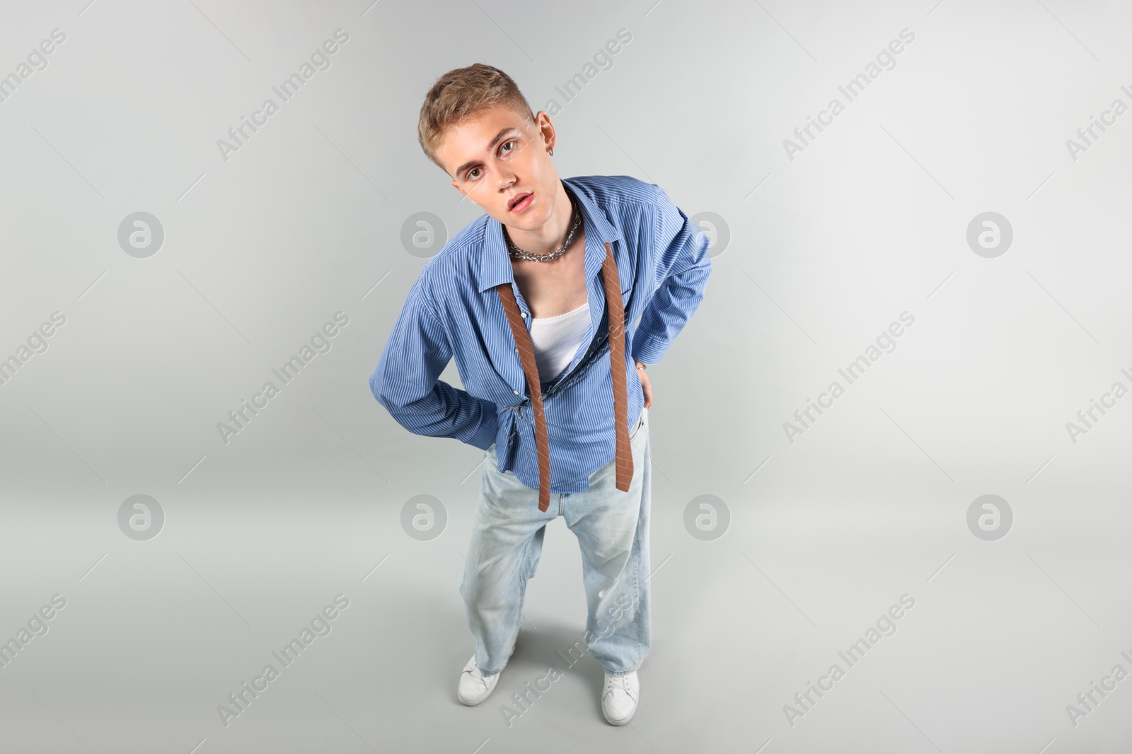 Photo of Handsome young man wearing stylish clothes on light grey background, above view
