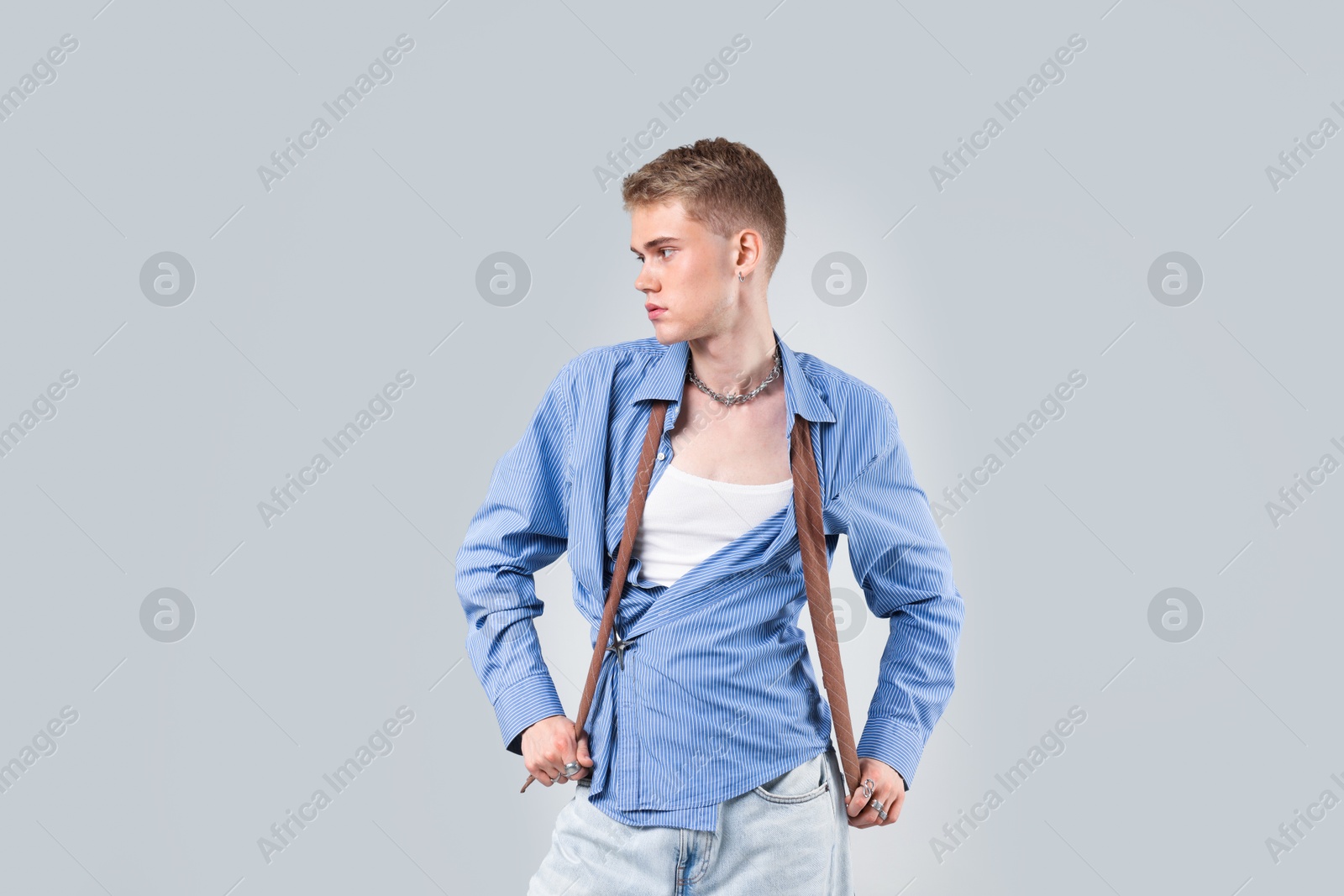 Photo of Handsome young man wearing stylish clothes on light grey background