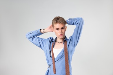 Photo of Handsome young man wearing stylish clothes on light grey background