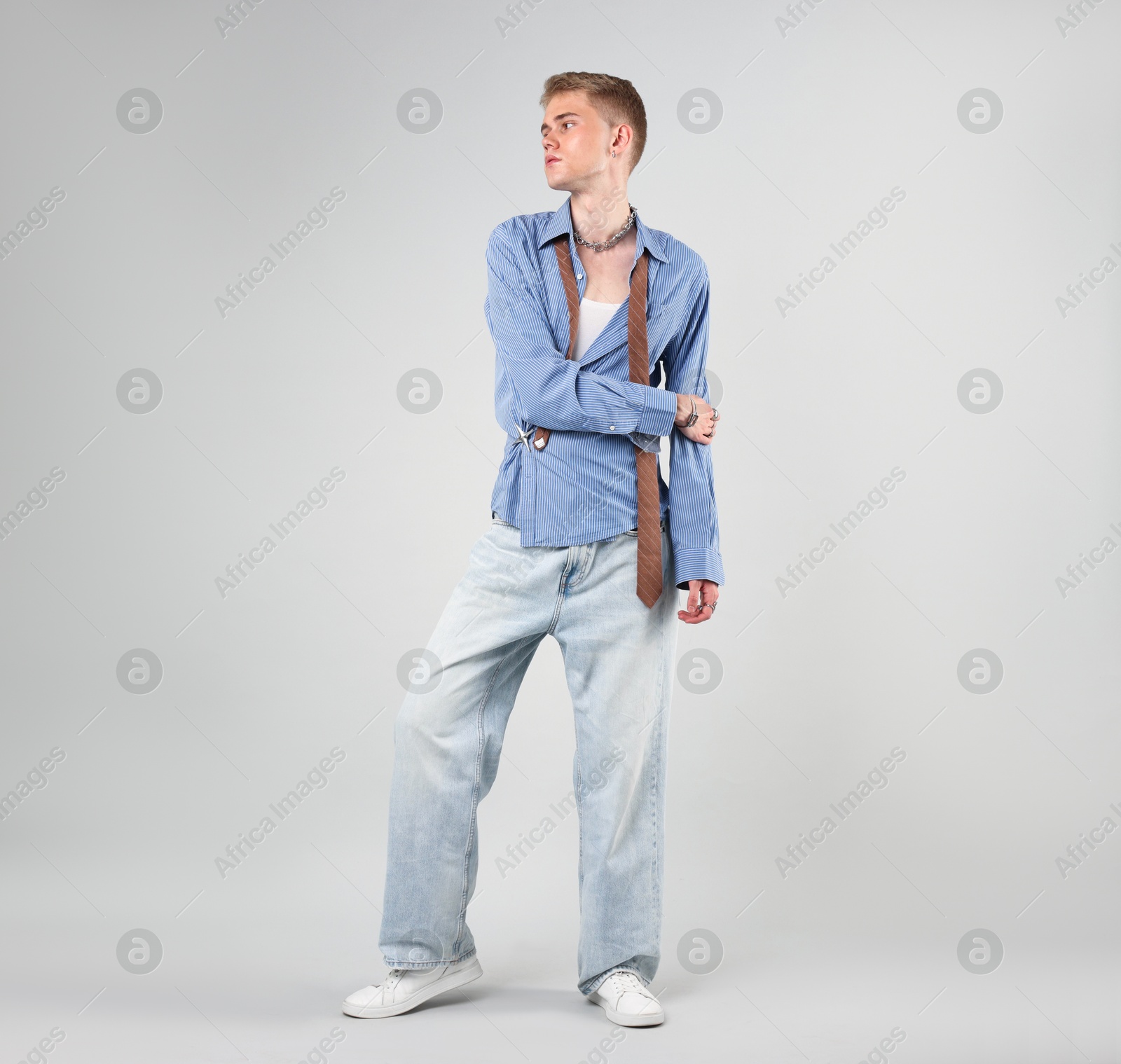 Photo of Handsome young man wearing stylish clothes on light grey background