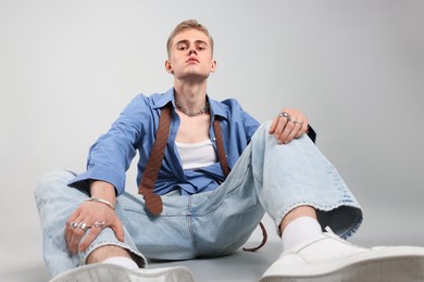 Photo of Handsome young man wearing stylish clothes on light grey background