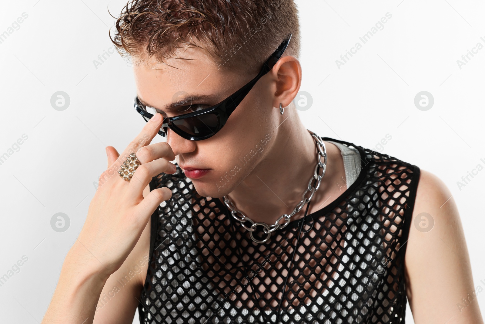 Photo of Handsome young man wearing sunglasses on white background