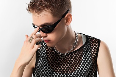 Photo of Handsome young man wearing sunglasses on white background