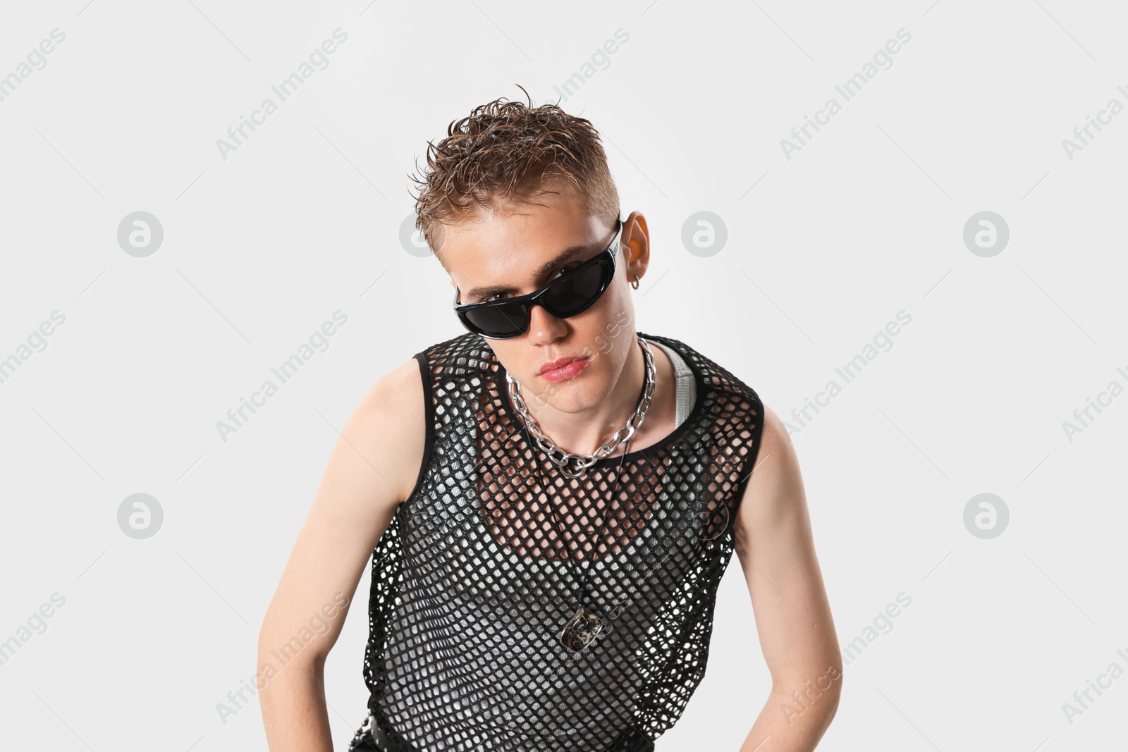 Photo of Handsome young man wearing sunglasses on white background
