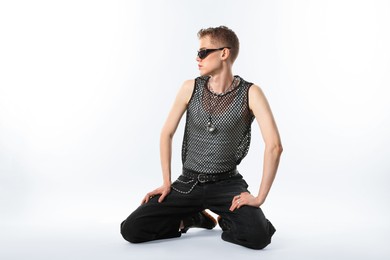 Photo of Handsome young man wearing sunglasses on white background