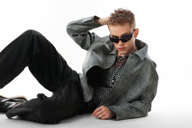 Photo of Handsome young man wearing stylish jacket and sunglasses on white background