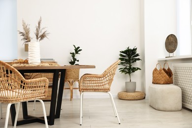 Photo of Stylish table with chairs and decor in dining room. Interior design