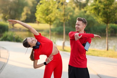 Photo of Happy couple doing morning exercise outdoors. Healthy lifestyle