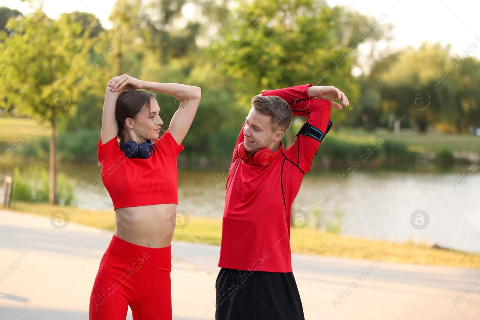 Photo of Happy couple doing morning exercise outdoors. Healthy lifestyle