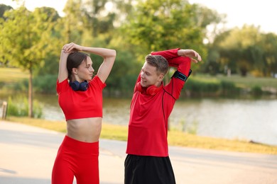 Photo of Happy couple doing morning exercise outdoors. Healthy lifestyle